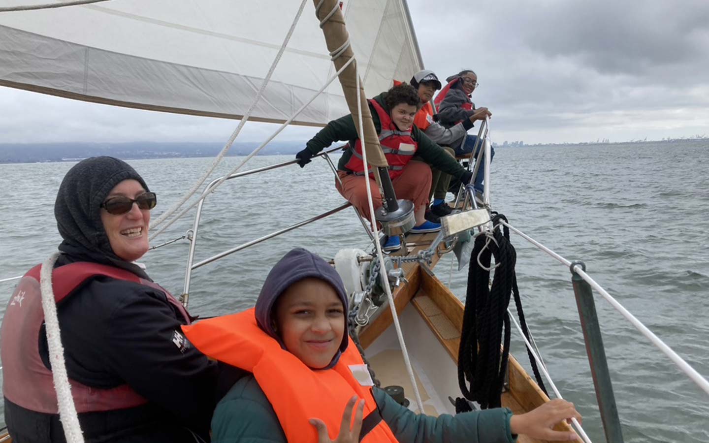 DeirdreAndKidsOnBowsprit Volunteer on bowsprit with kids