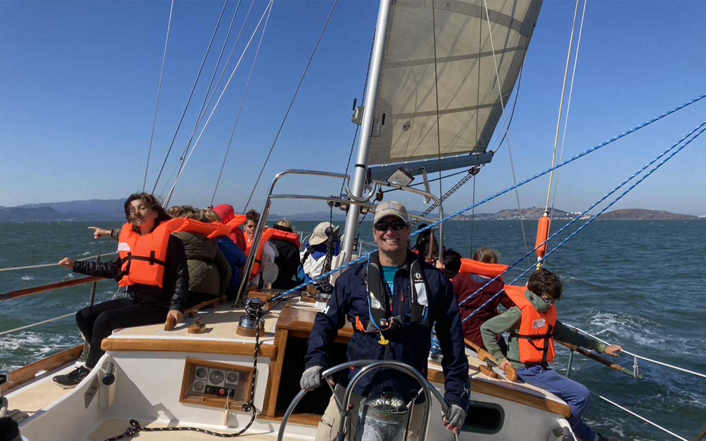 Smiling Helmsman with School Kids Smiling helmsman with school group on Pegasus